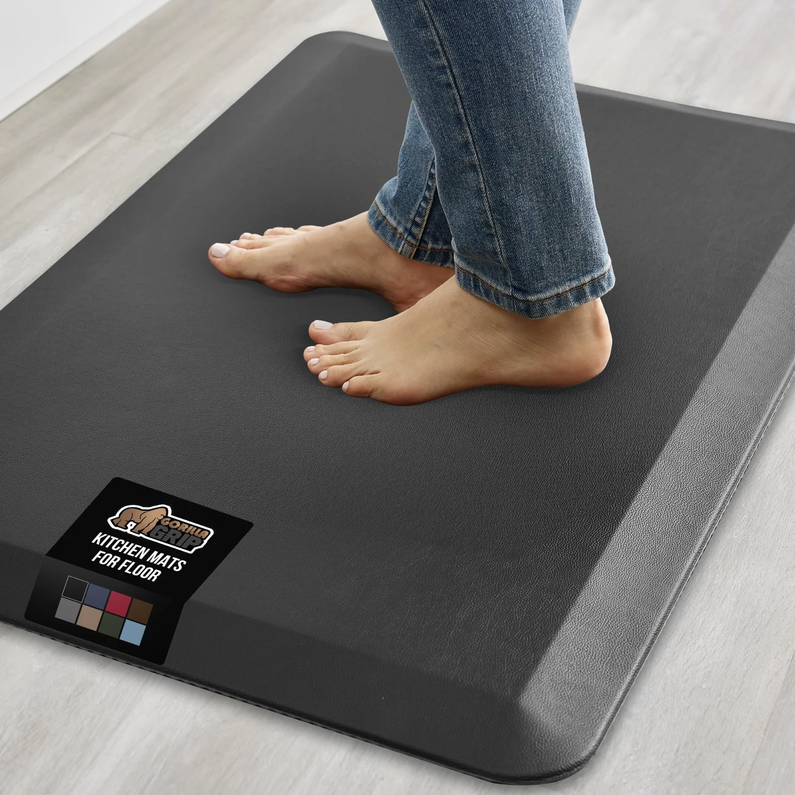 Bare feet on a cushioned kitchen mat, at the length of a working line.